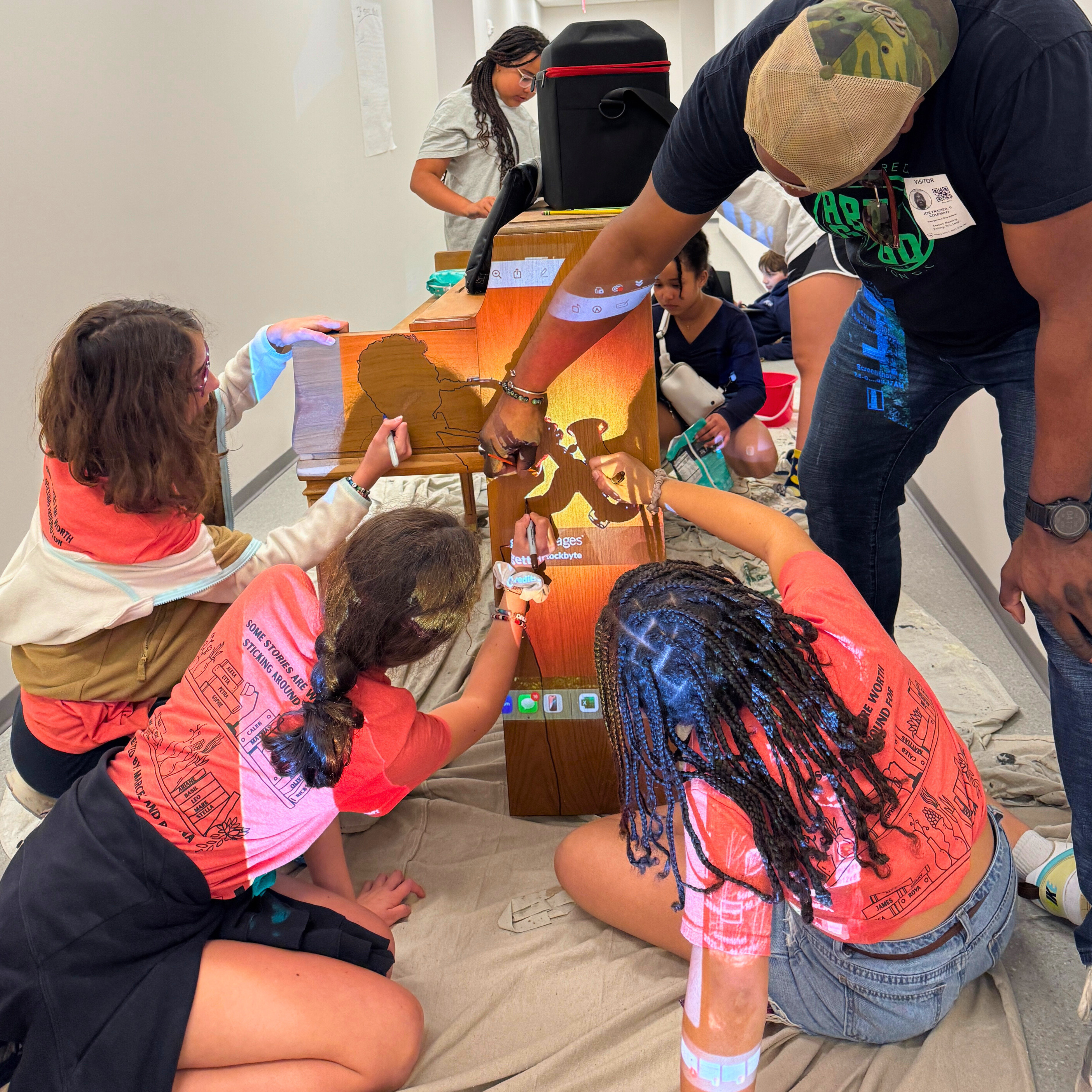 Jay Coleman and students painting